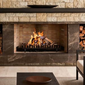 Traditional Wood Built-in fireplace with fire and stone surround